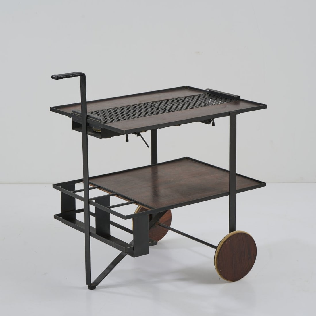 Cees Braakman, Serving trolley, c. 1960: H. 70 x 65 x 47 cm. Made by UMS Pastoe, Utrecht. Metal tube, metal sheet, painted black, brass sheet, plywood with teak veneer, stained dark, black leather strap.