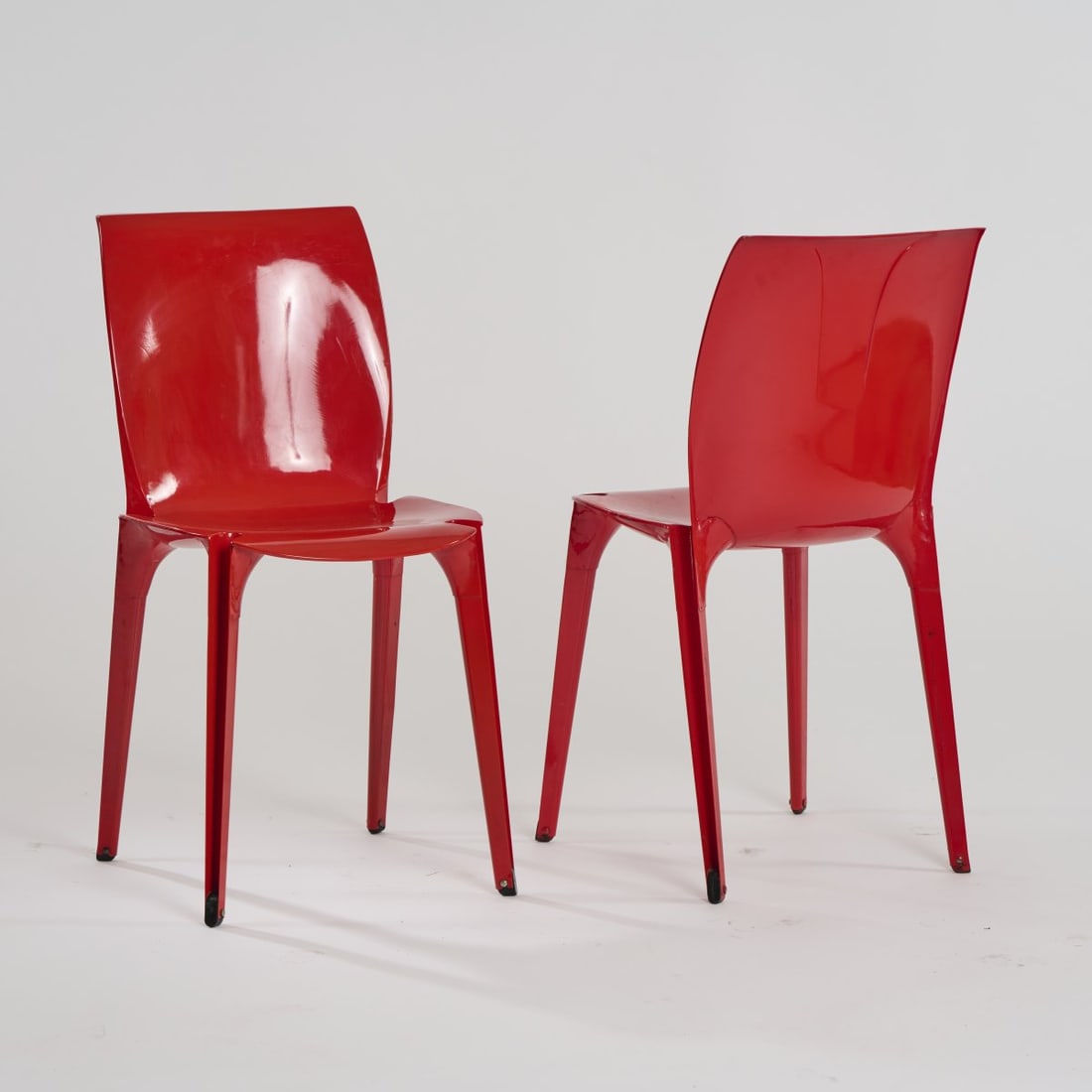 Marco Zanuso and Richard Sapper, Two 'Lambda' chairs, 1963: H. 77.5 x 39.5 x 46.5 cm. Made by Gavina, Milan. Sheet metal, painted red, black rubber feet. Literature: Gramigna, Repertorio 1950-2000, vol. 1, Turin 2003, p. 100.
