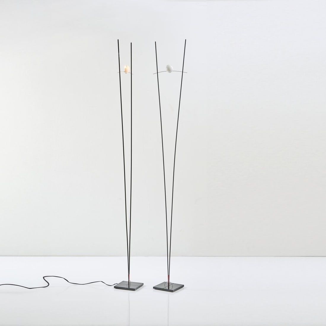 Ingo Maurer; Franz Ringelhan, Two floor lamps 'Ilios', 1983: H. 191 cm. Made by Design M, Maurer, Ingo, Munich. Metal, metal rods, painted black, orange Plexiglas insulator. Marked: manufacturer's sticker. Literature: Bauer (ed.), Ingo Maurer Making Light, Mun