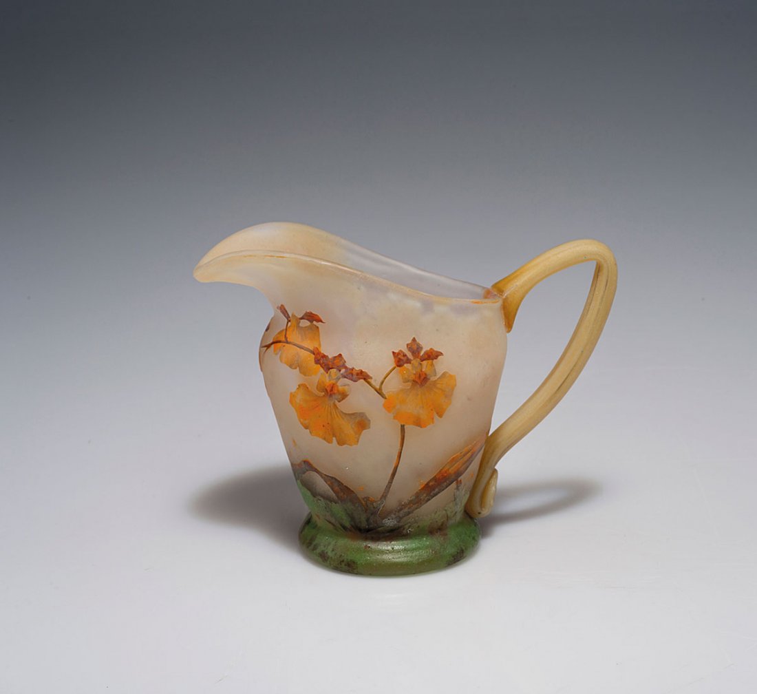 Orchidees' jug, c1905: Daum Freres, Nancy. 'Orchidees' jug, c1905. H. 10.4 cm. Cased glass, white and light yellow, in the lower part orange and pink powder inclusions, dark green, partly auburn enamel fusions (vitrificatio