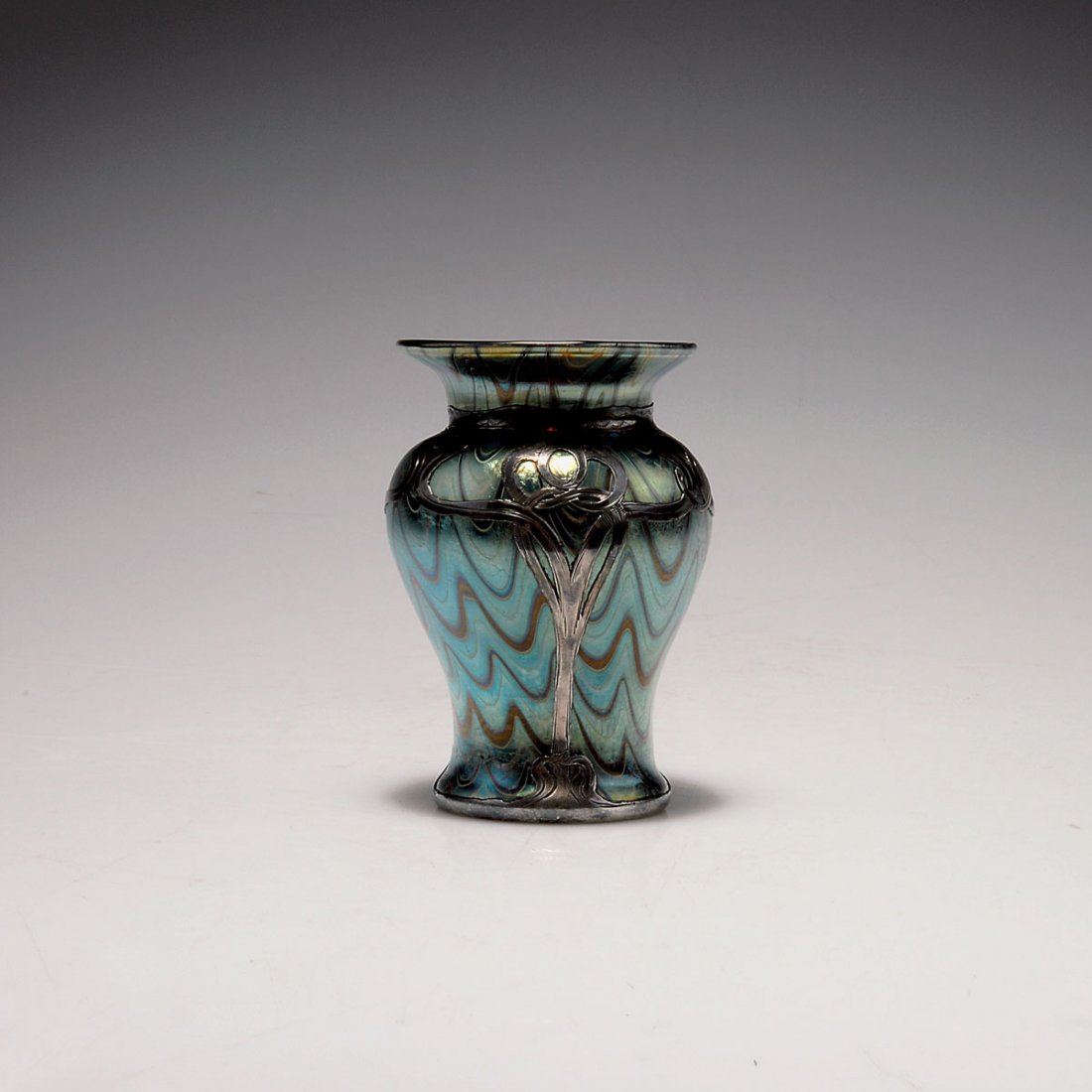 Phanomen' vase, 1898: Loetz, Klostermuhle. 'Phanomen' vase, 1898. H. 10.6 cm. Cased glass, clear and ruby red, dense silver threads, wavy, Phanomen Gre 6893, matt mother-of-pearl and bluish lustre. Galvanic silver overlay,