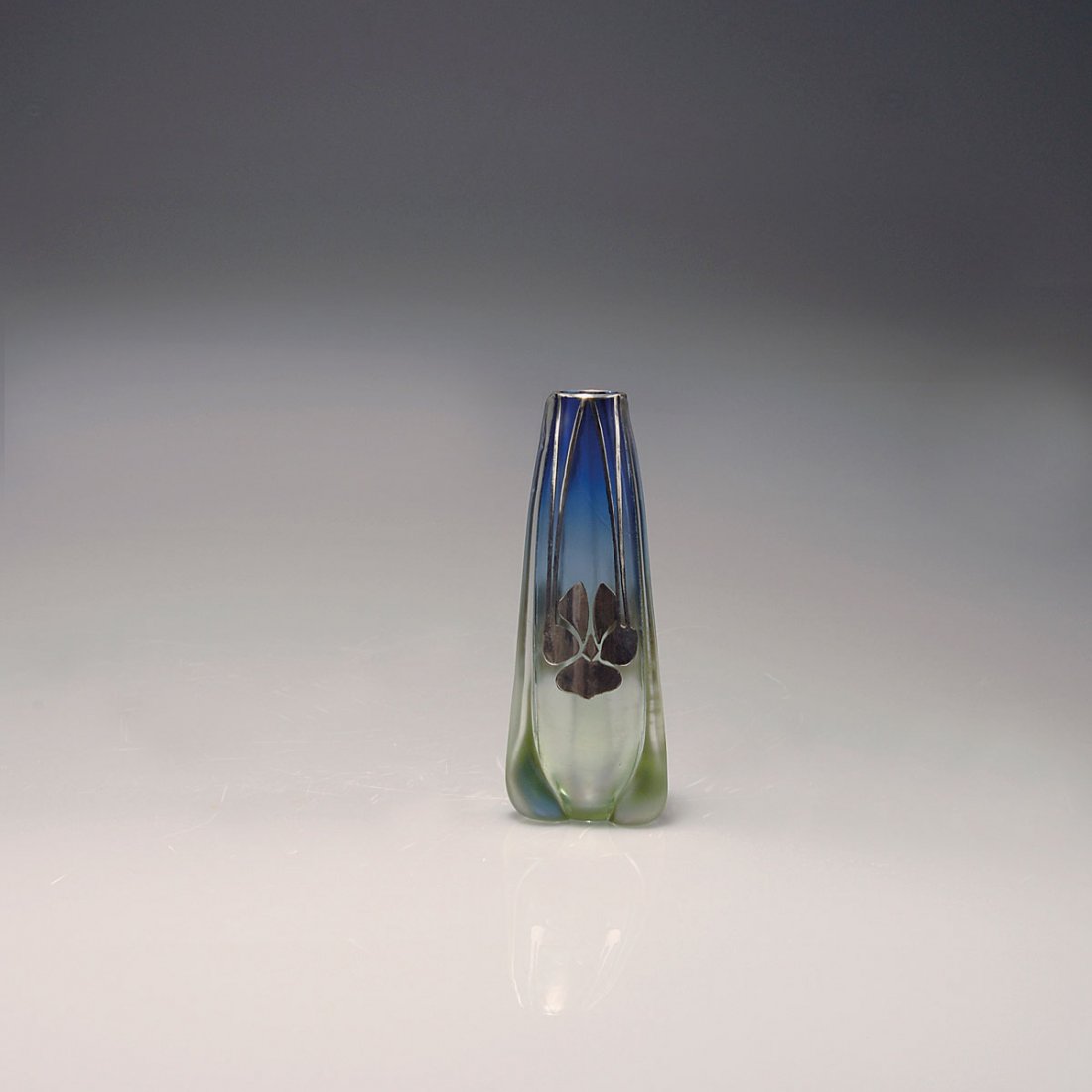 'Luna' vase with silver-overlay, 1901: Loetz, Klostermuhle. 'Luna' vase with silver overlay, 1901. H. 12.5 cm. Designed in the manner of Koloman Moser. Made for E. Bakalowits Sons, Vienna. Prod. no. 85/3872. Cased glass, slightly green-blu