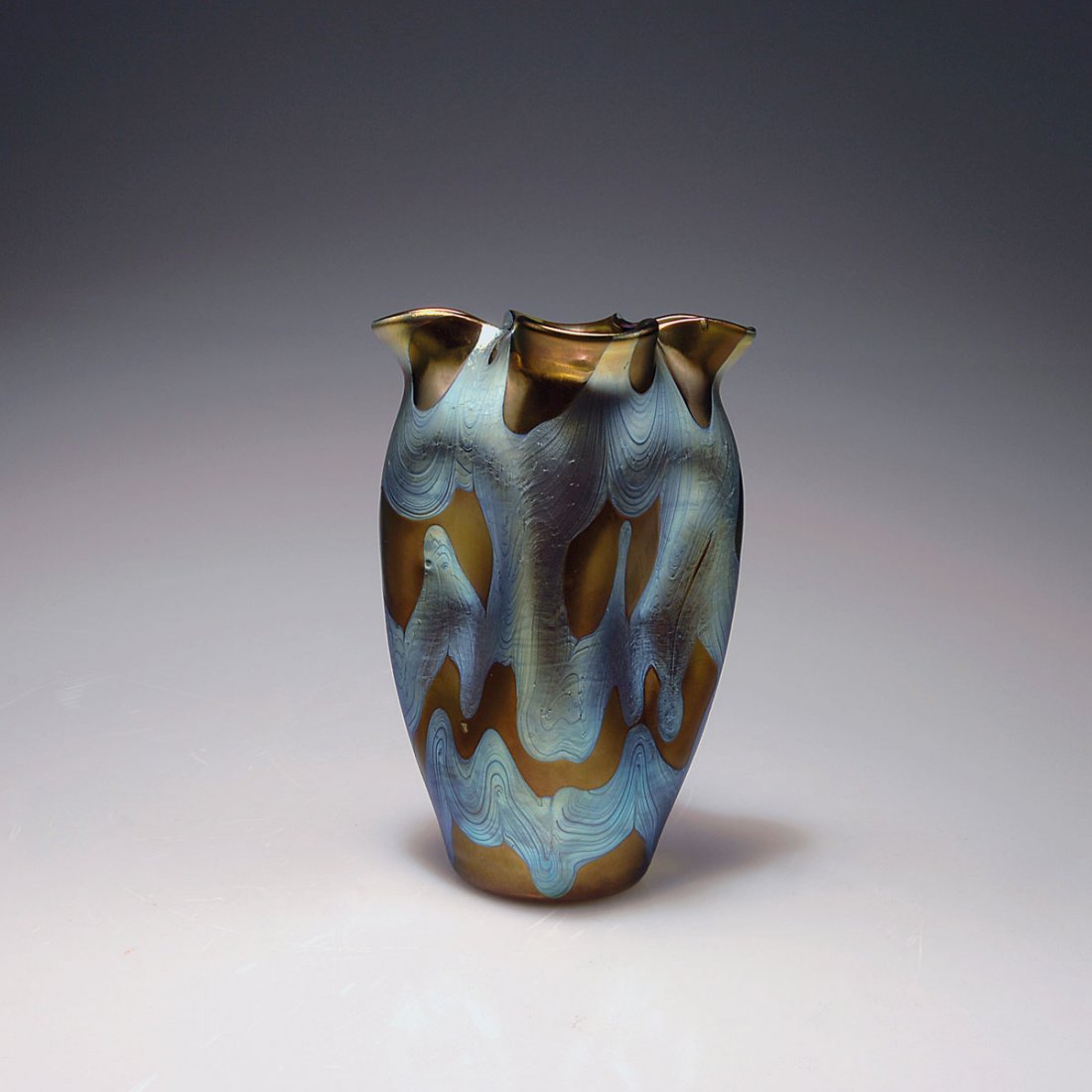 Phanomen' vase, 1900: Loetz, Klostermuhle. 'Phanomen' vase, 1900. H. 18.6 cm. Moss green glass, combed pattern of silver yellow threads, bronce Phanomen Gre 29, oxidised, strong mother-of-pearl and blue lustre. Signed: Loe