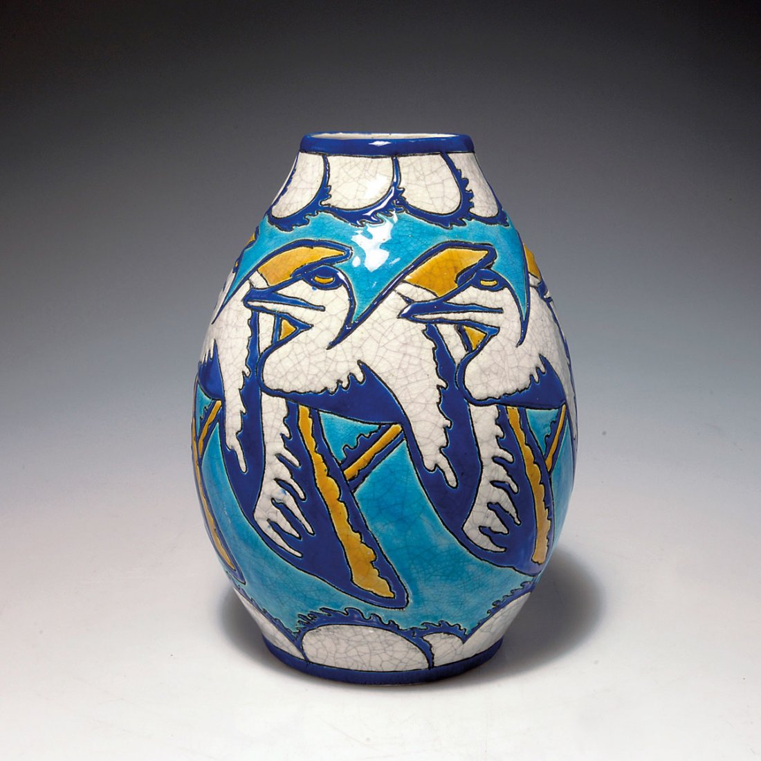Pelicans' vase, c1925: Boch Freres, La Louviere. 'Pelicans' vase, c1925. H. 24.7 cm. Designed by Charles Catteau. Earthenware, enamel in light- and dark blue and yellow on white, grey craquelure, pelicans flying over waves.