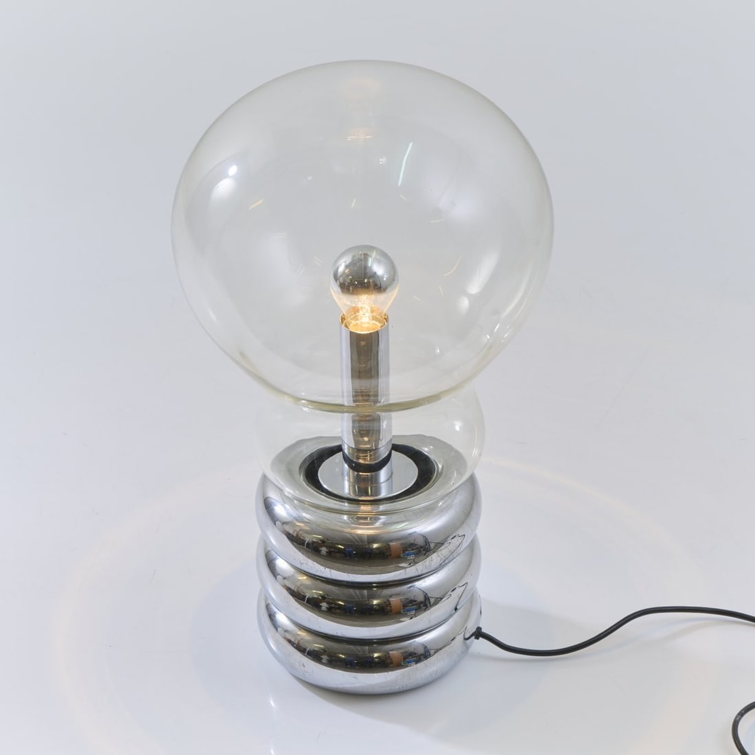 Ingo Maurer, 'Giant Bulb Clear' table light, 1966 (design): H. 56 cm. Ø 33 cm.Design M, Ingo Maurer, Munich. Chrome-plated sheet metal, clear glass. Marked: manufacturer's label. Literature: Bauer (ed.), Ingo Maurer Making Light, Munich 1992, p. 26, p.