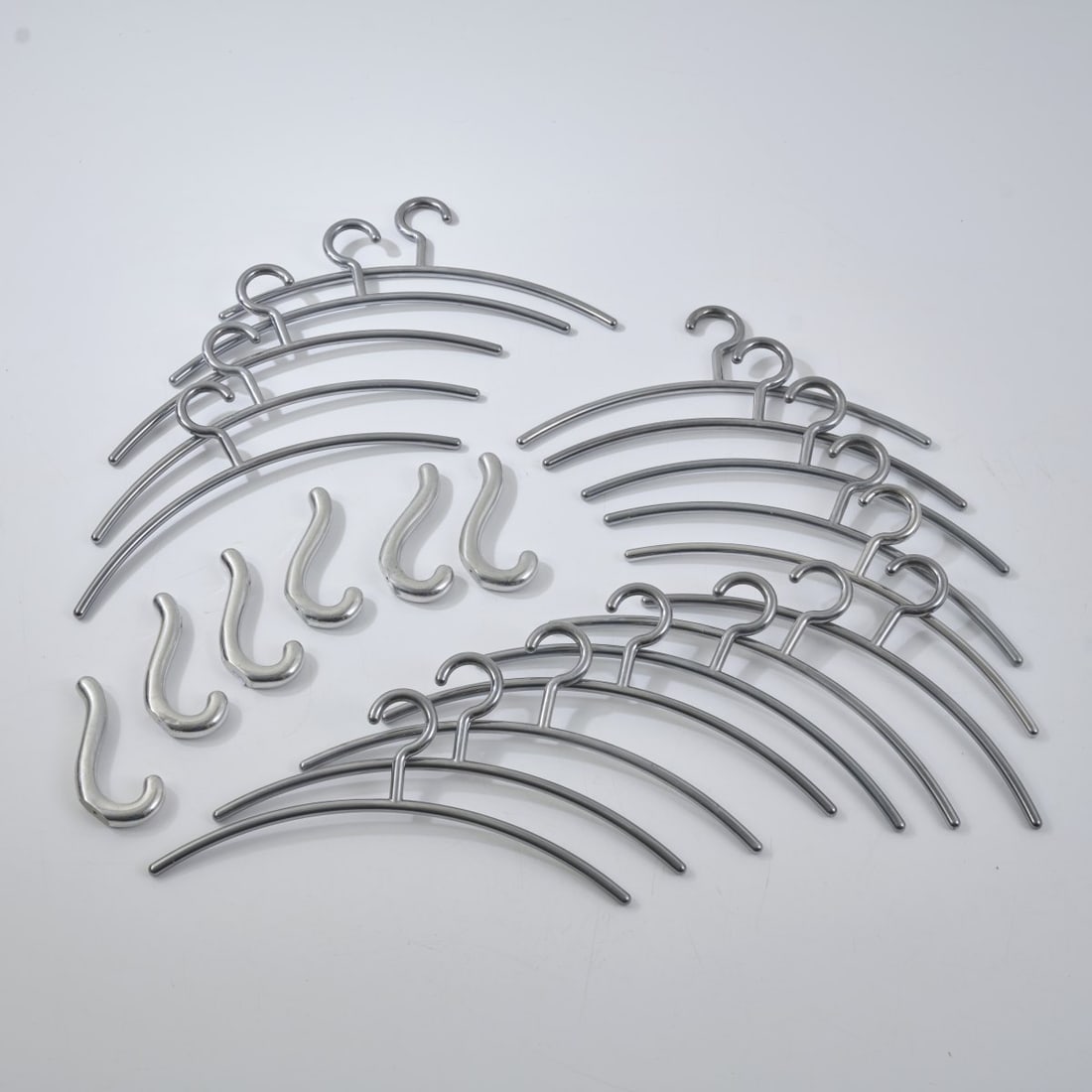 Ingo Maurer, 17 Cloth hangers and six wall hooks, 1968 (design): Hangers: H. 18.5 x 42 cm; Hooks: H. 16 x 2 x 6,5 cm. Design M, Ingo Maurer, Munich. Aluminum, metal, chrome plated. Literature: Bauer (ed.), Ingo Maurer Making Light, Munich 1992, p. 33, p. 248, p. 4