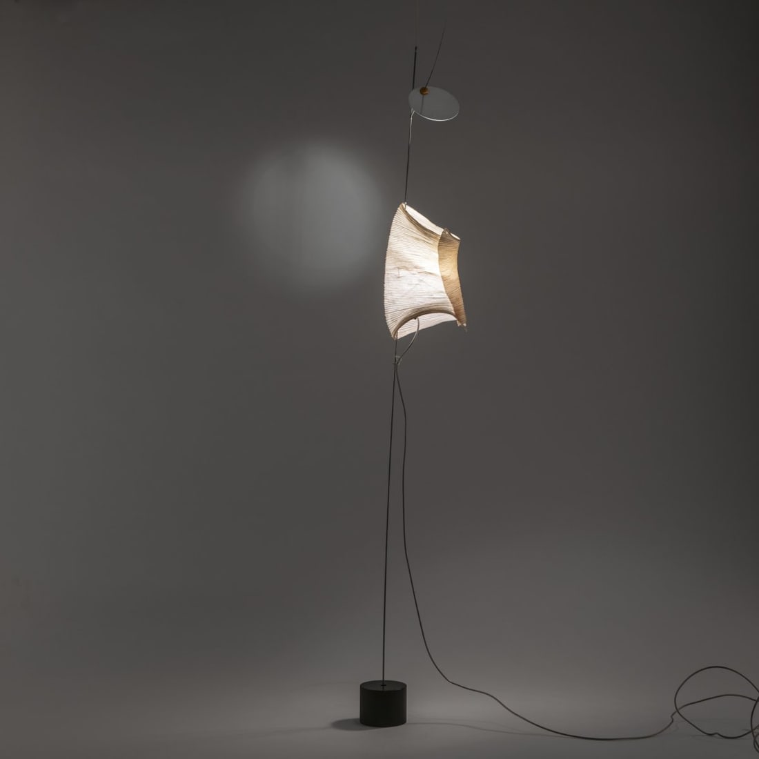 Dagmar Mombach; Ingo Maurer, Table light 'The Tribe - Watapunga', 1998 (design): H. 115 cm, Ø 11 cm. Design M Ingo Maurer, Munich. Paper, metal, silicone, glass, aluminum, adjustable mirror. Base in brass. Marked: manufacturer's sticker.