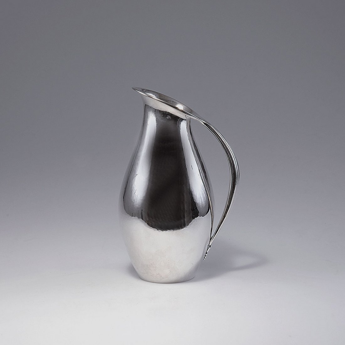 '432C' jug, 1920: Johan Rohde. '432C' ewer, 1920. H. 29 cm. Made by Georg Jensen, Copenhagen. Silver. Marked: DESSIN JR, DENMARK, GEORG JENSEN, STERLING, 432, E.