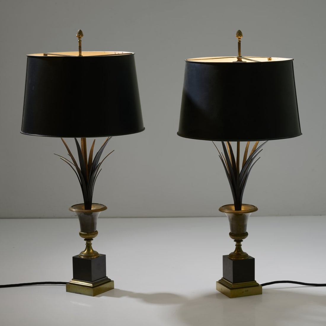 Maison Charles, Paris, Two table lights, 1970s: H. 75.5 cm, Ø 35.5 cm.Sheet metal and metal tube, burnished, brass sheet, sheet metal, painted black and white.