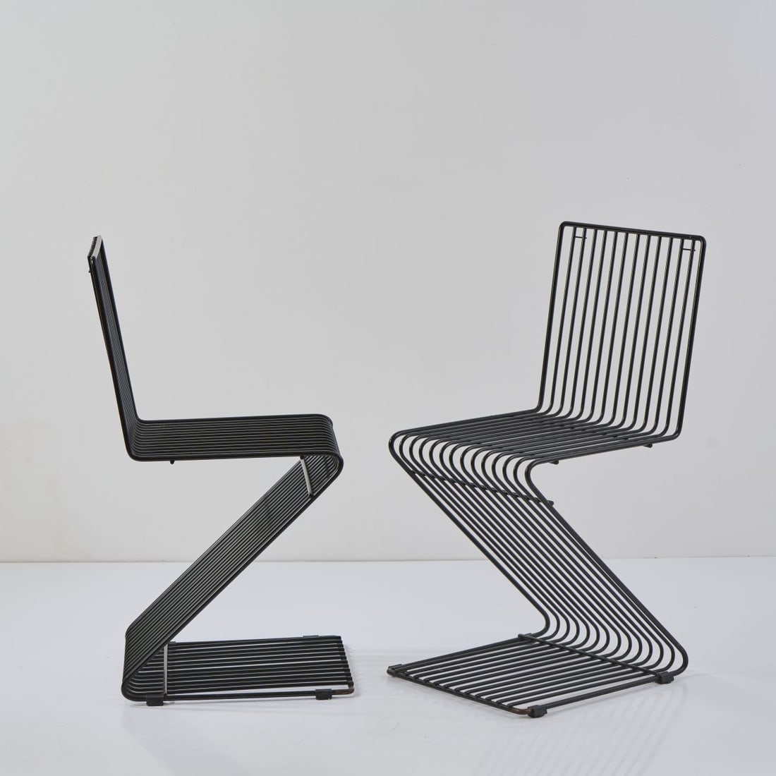 François Arnal, Two 'Z' chairs, 1970 (design): H. 81 x 38 x 47 cm. Atelier A, Paris.Metal rods, painted black.