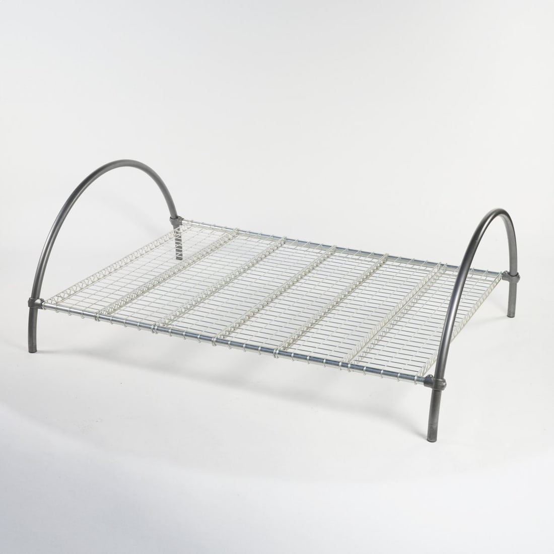 Ron Arad, 'Round Rail Bed', um 1982: H. 78 x 152 x 211 cm. One Off Studio, Ron Arad, London. Metal tube, metal grid, chrome-plated, partially painted grey. Literature: Sudjic, Ron Arad, Restless Furniture, London 1989, p. 45.