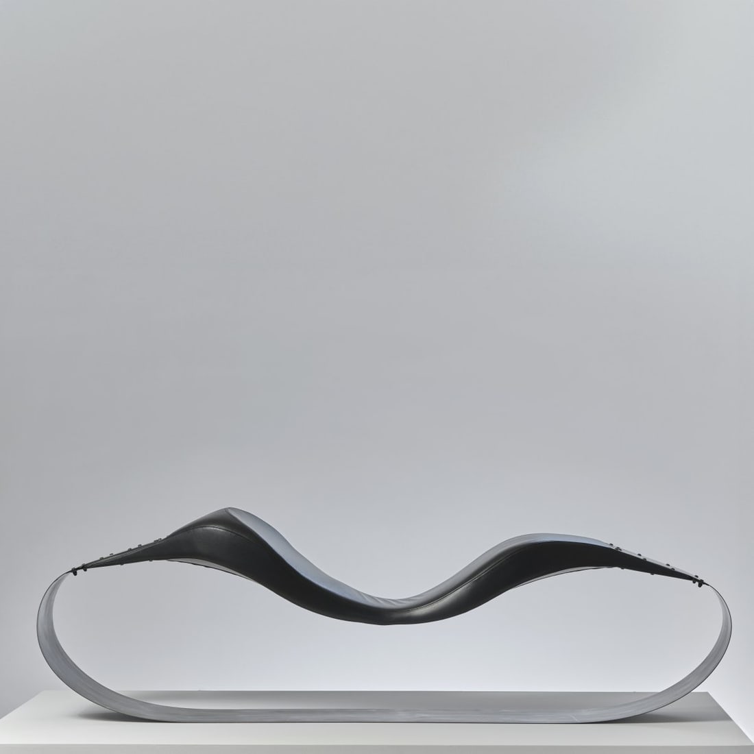 Ron Arad, 'Spring' seat, 1990 (design): H. 69 x 55 x 230 cm. Moroso, Tavagnacco. Burnished sheet metal, polyurethane foam, black leather. Literature: Sudjic, Ron Arad, Munich 1999, p. 45.