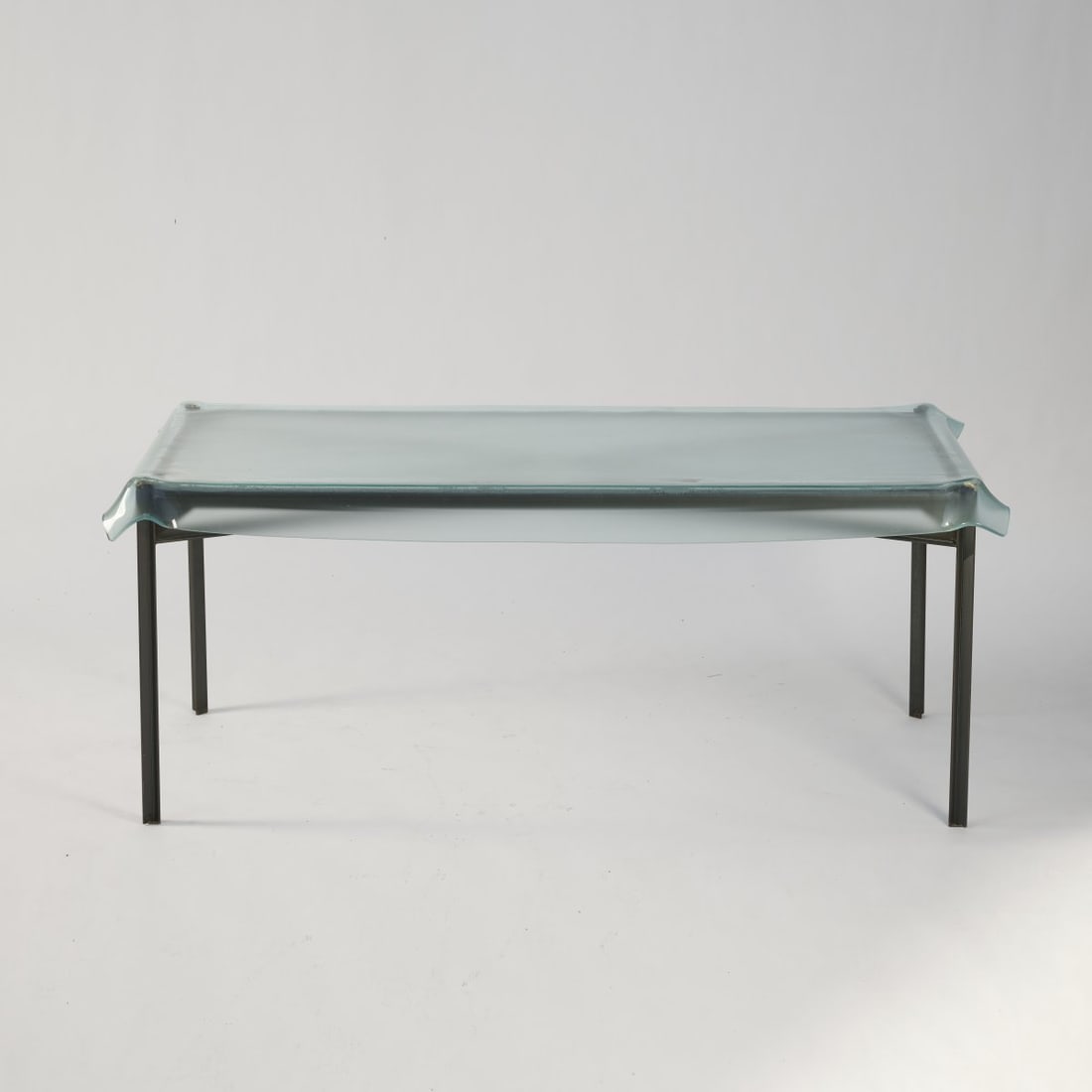 Philippe Starck, 'Illusion' table, 1992 (design): H. 77 x 198 x 103 cm. Fiam, Pesaro. Sectional metal, blackened, brass, glass, transparent matt. Marked: Stamps on three of four support points (legs): FIAM, STARCK, 120. Literature: Philippi, STARCK,