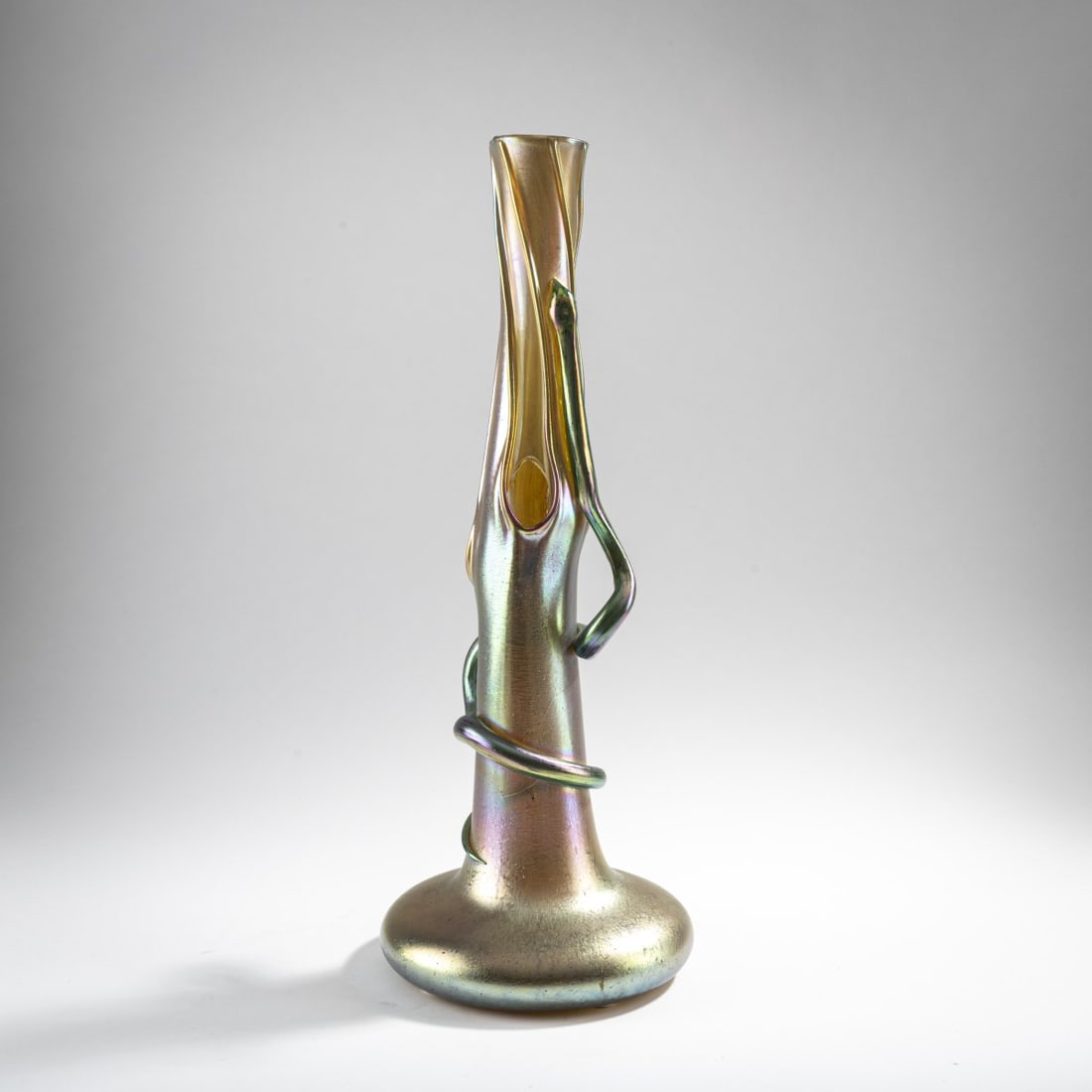Loetz, Klastersky Mlyn, 'Tree trunk vase' with snake, 1902: H. 43 cm. Colorless glass, dense silver-yellow crumb fusions, gold and pearlescent matt luster, candia Silberiris. Literature: Cf. Ricke/Ploil, Lötz Böhmischess, Vol. I, Munich 1989, No. 14