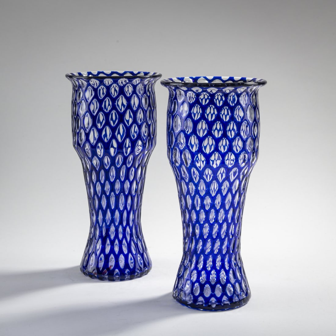 Loetz, Klastersky Mlyn, Two vases, 1911: H. 22.8-22.9 cm. Colorless glass, fused blue glass. Star cut on the base. Execution 119.