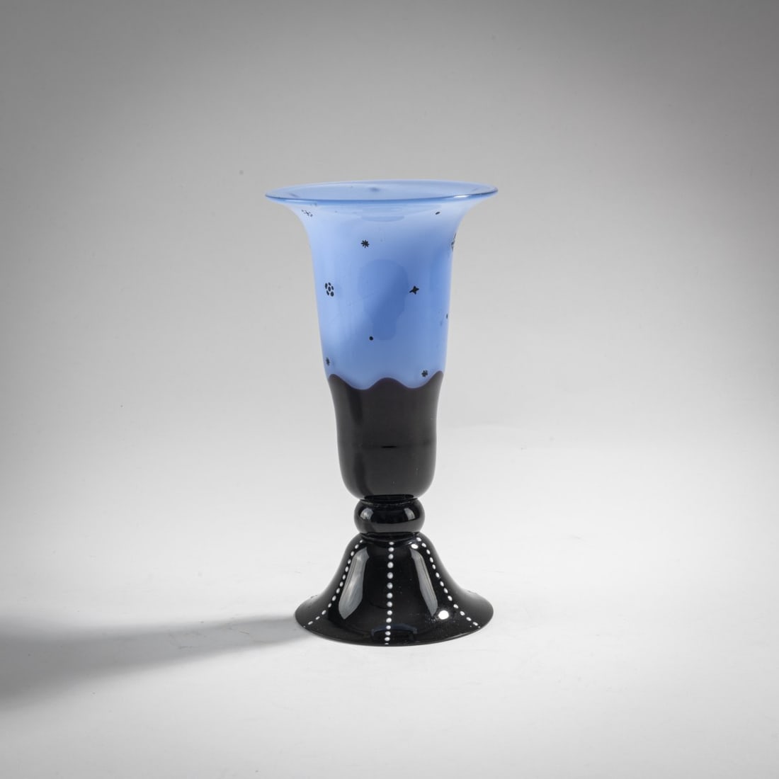 Loetz, Klastersky Mlyn, Vase, c. 1920: H. 18.8 cm. Cased glass, colorless, opal blue and deep violet. White enamel drops, black solder decoration in the style of Dagobert Peche.