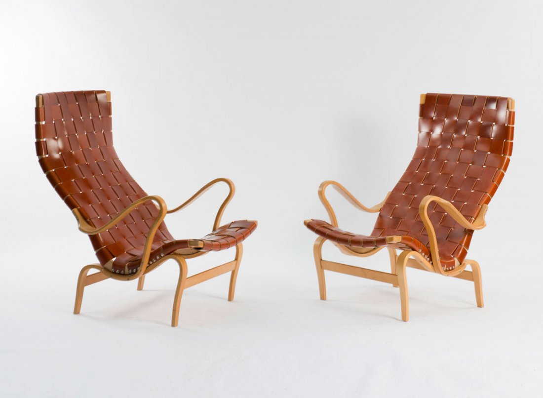 Bruno Mathsson. Pair of 'Eva' armchairs, 1936. H. 99 x : Bruno Mathsson. Pair of 'Eva' armchairs, 1936. H. 99 x 73 x 88 cm. Made by DUX, Trelleborg. Birch plywood, red brown leather. Marked: Maker's mark with facsimilised designer's signature.