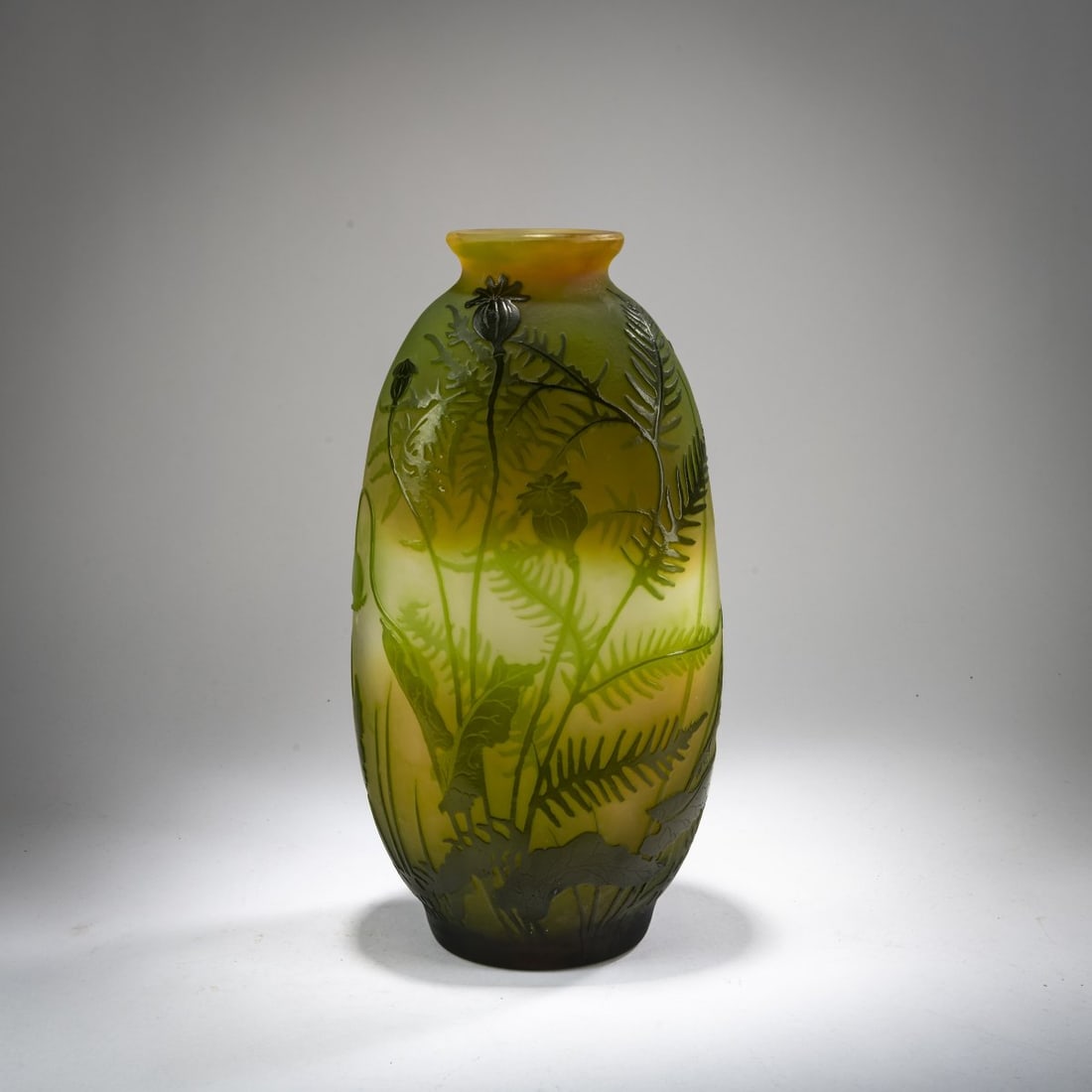 Etablissements Gallé, Nancy, Vase 'Fougères et Pavots', 1908-20: <p>H. 32 cm. Cased glass, amber, colorless, and green. Etched decoration with wall fern and poppy capsules in an evening setting. Signed: Gall&eacute; with star (raised).</p>