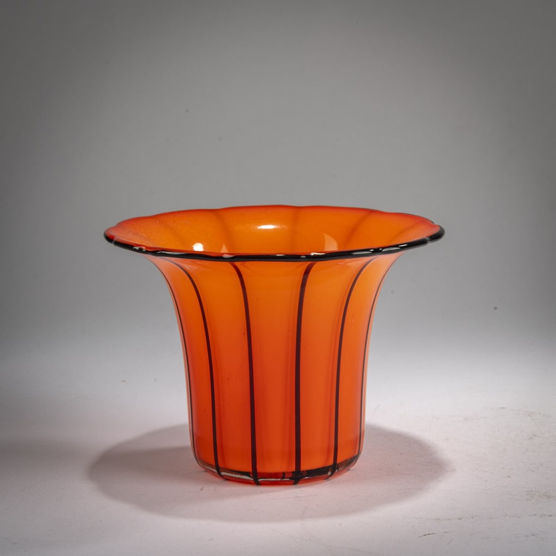 Michael Powolny, Vase, 1914: <p>H. 10 cm. Execution: Loetz, Klastersky Mlyn. Cased glass, colorless and opaque orange. Applied black stripes. Execution 157. </p><hr><p>Literature:</p><p>Ricke/P