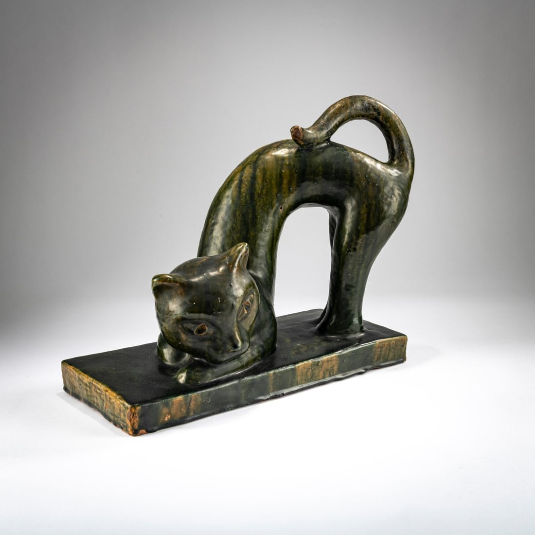 Wiener Kunstgewerbeschule, Majolica figurine 'Cat', 1920s: <p>H. 28 cm, 35 x 14.5 cm. Majolica, glazed camouflage green and yellow. Marked: KG WIEN (stamped), GF (incised). </p>