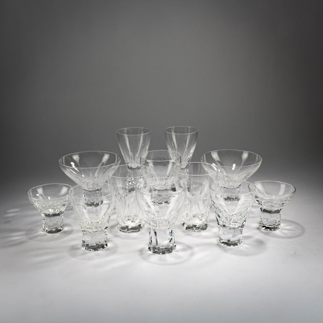 Wilhelm Wagenfeld, 74 drinking glasses 'Prisma', 1952/53 (design): <p>H. 7 - 13.5 cm. <br />Peill &amp; Putzer, D&uuml;ren (c. 1958). <br />Glass, transparent. <br />Marked: manufacturer's signet (sandblasted).</p><hr><p