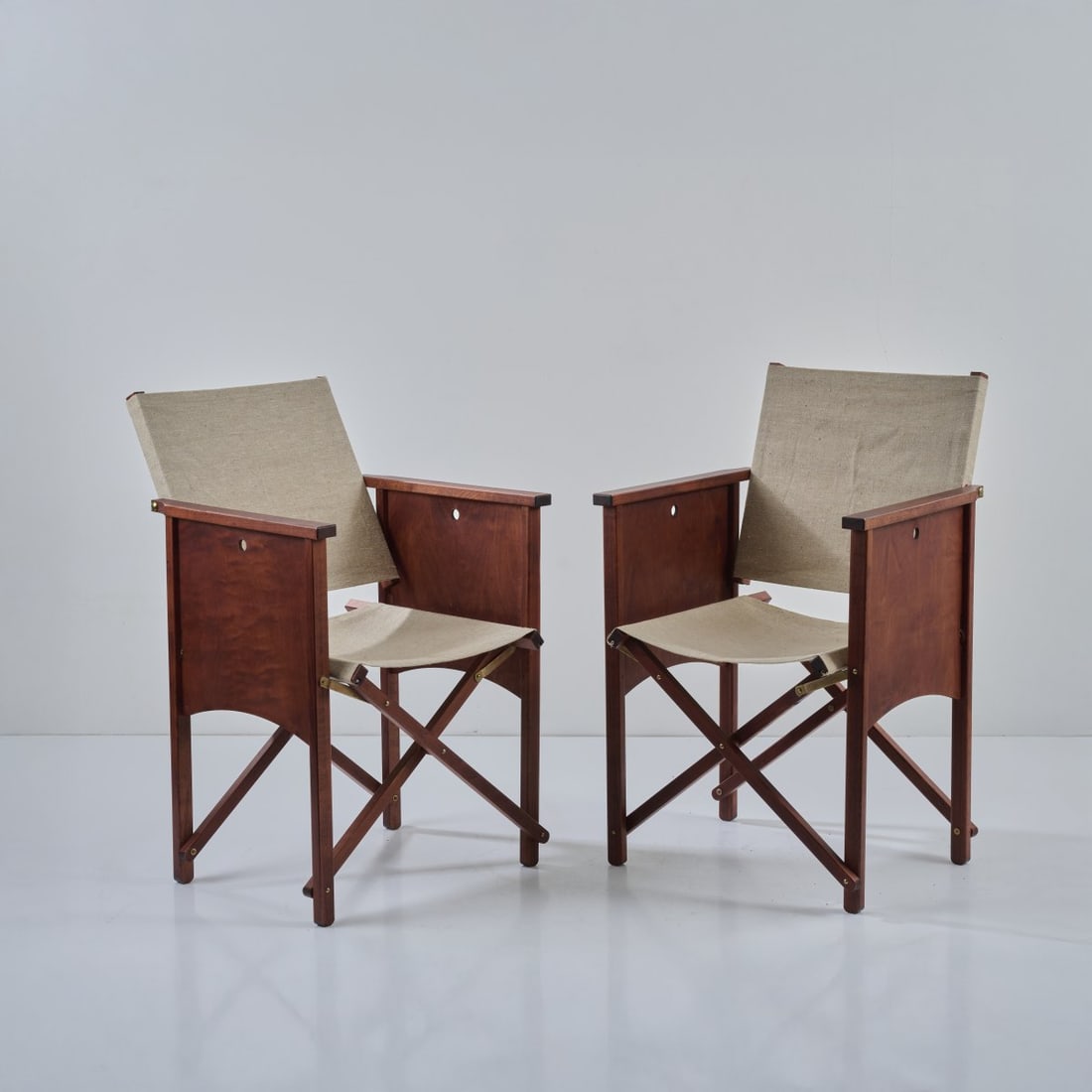 Philippe Starck, Two folding chairs 'Monsieur X', 1996: <p>H. 87 x 54 x 51 cm. <br />XO, Paris. <br />Dark-stained wood, linen fabric, brass fittings.</p>