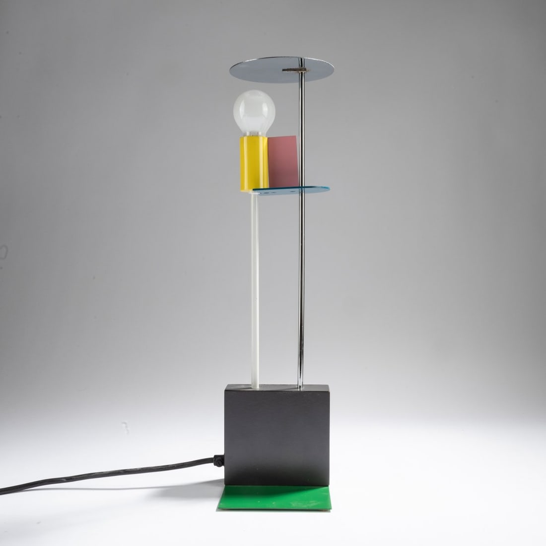 Gerard Taylor, Table light 'Picadilly', 1982 (design): <p>H. 45 x 15 x 11 cm. <br />Memphis Milano, c. 1993.<br />Sheet metal, metal tube, chrome-plated, color varnished or laminated. <br />Marked: Manufacturer's metal plaque Memph