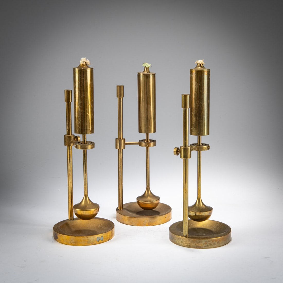 Ilse D. Ammonsen, Three kerosene candlesticks, c. 1950: <p>H. 21.5 cm (with wick). <br />Cast brass, sheet brass. <br />Marked: &copy; Ilse D. Ammonsen.</p>
