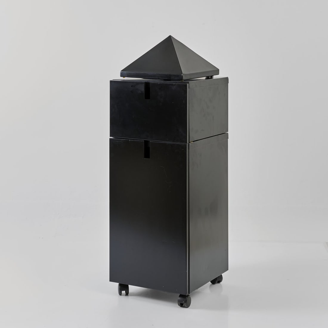 Philippe Starck, Cabinet 'Theatre du Monde', 1984 (design): <p>H. 115 x 39 x 41 cm.<br />XO, Brie-Comte-Robert. <br />Black lacquered sheet metal, casters.</p><hr><p>Literature:</p><p>Philippi (ed.), STARCK, Colo