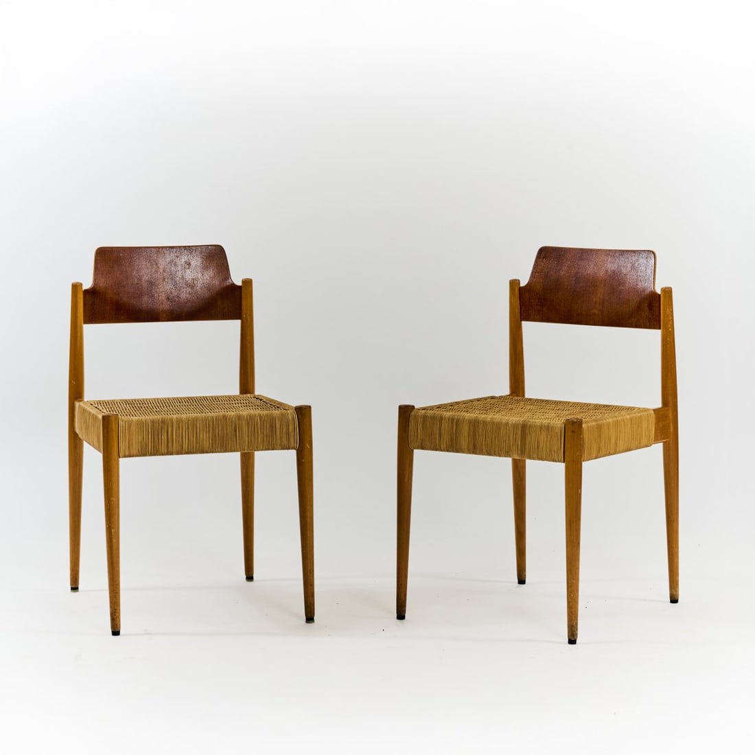Egon Eiermann, Two chairs 'SE 119', 1952/53: <p>H. 79 x 43 x 46.5 cm. <br />Wilde &amp; Spieth, Esslingen. <br />Beechwood, plywood with teak veneer, rattan weave.</p><hr><p>Literature:</p><p>E