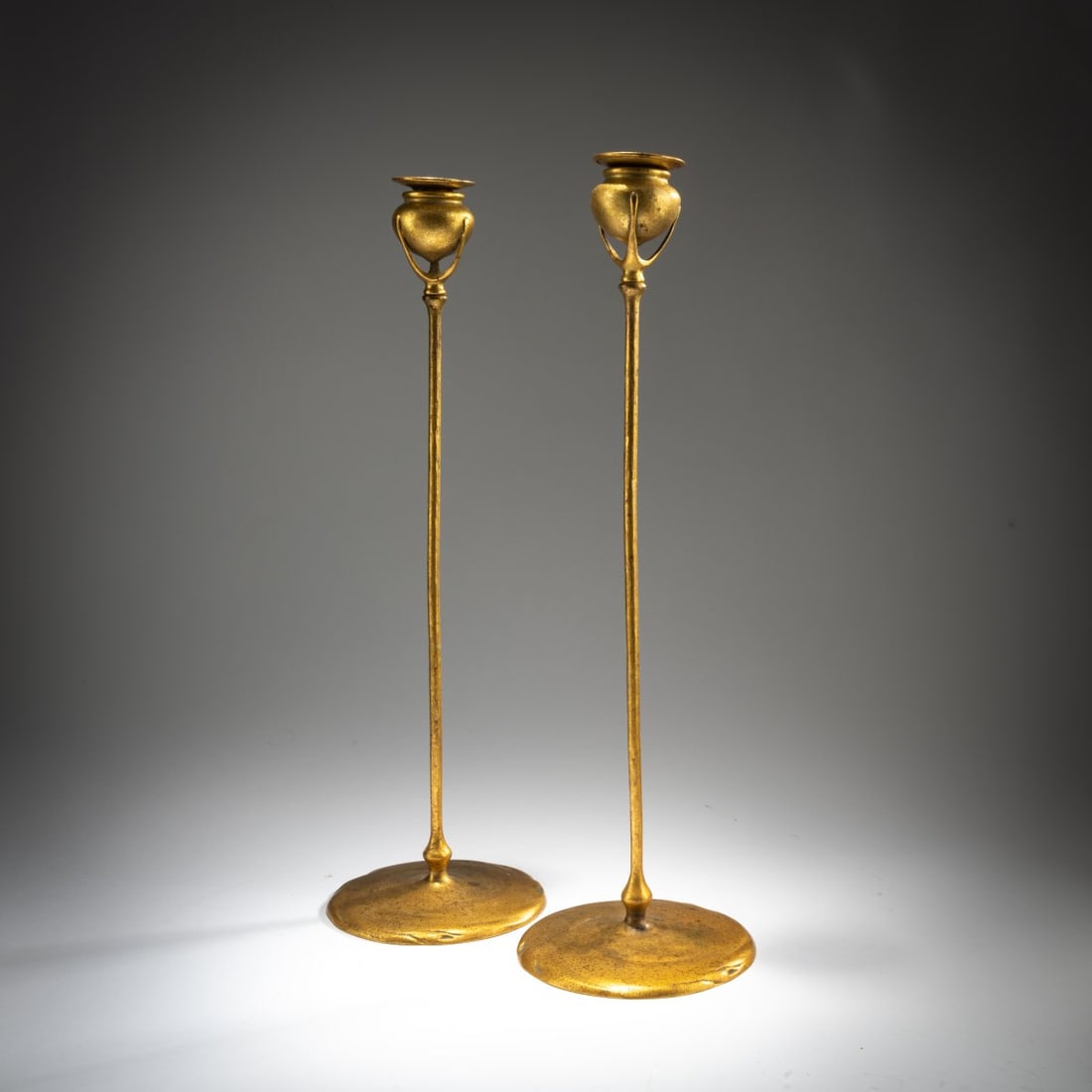 Tiffany Studios New York, Two candlesticks '1213', c. 1902: <p>H. 47 cm. Cast bronze, gilded. Marked: TIFFANY STUDIOS NEW YORK 1213 (stamped).</p><hr><p>Literature:</p><p>Koch, Louis Comfort Tiffany's Glass - Bronzes - Lamps