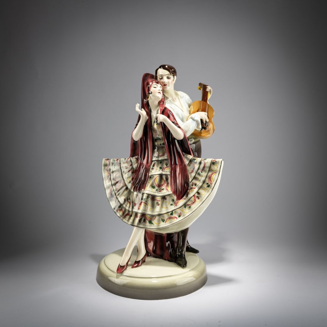 Josef Lorenzl, 'Group of standing dancer in fan-shaped dress, behind her a man with a violin', c.: <p>H. 44 cm. Execution: Friedrich Goldscheider, Vienna. Earthenware, polychrome glaze. Bottom marked: MADE IN AUSTRIA, Goldscheider Wien, Hand Decorated (black glaze stamp), 58718575 (embossed),