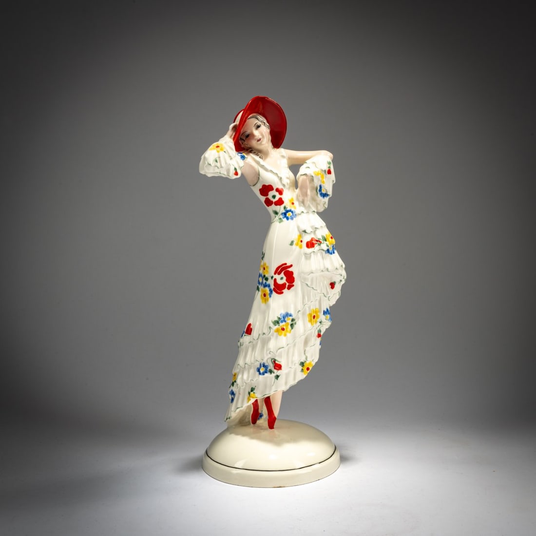 Josef Lorenzl, 'Standing young lady with large hat (in pose), c. 1930: H. 32 cm. Execution: Friedrich Goldscheider, Vienna. Earthenware, polychrome glaze. Base signed: Lorenzl (stamped). Bottom marked: Goldscheider Wien (black glaze stamp), fabriqué en Autriche (g