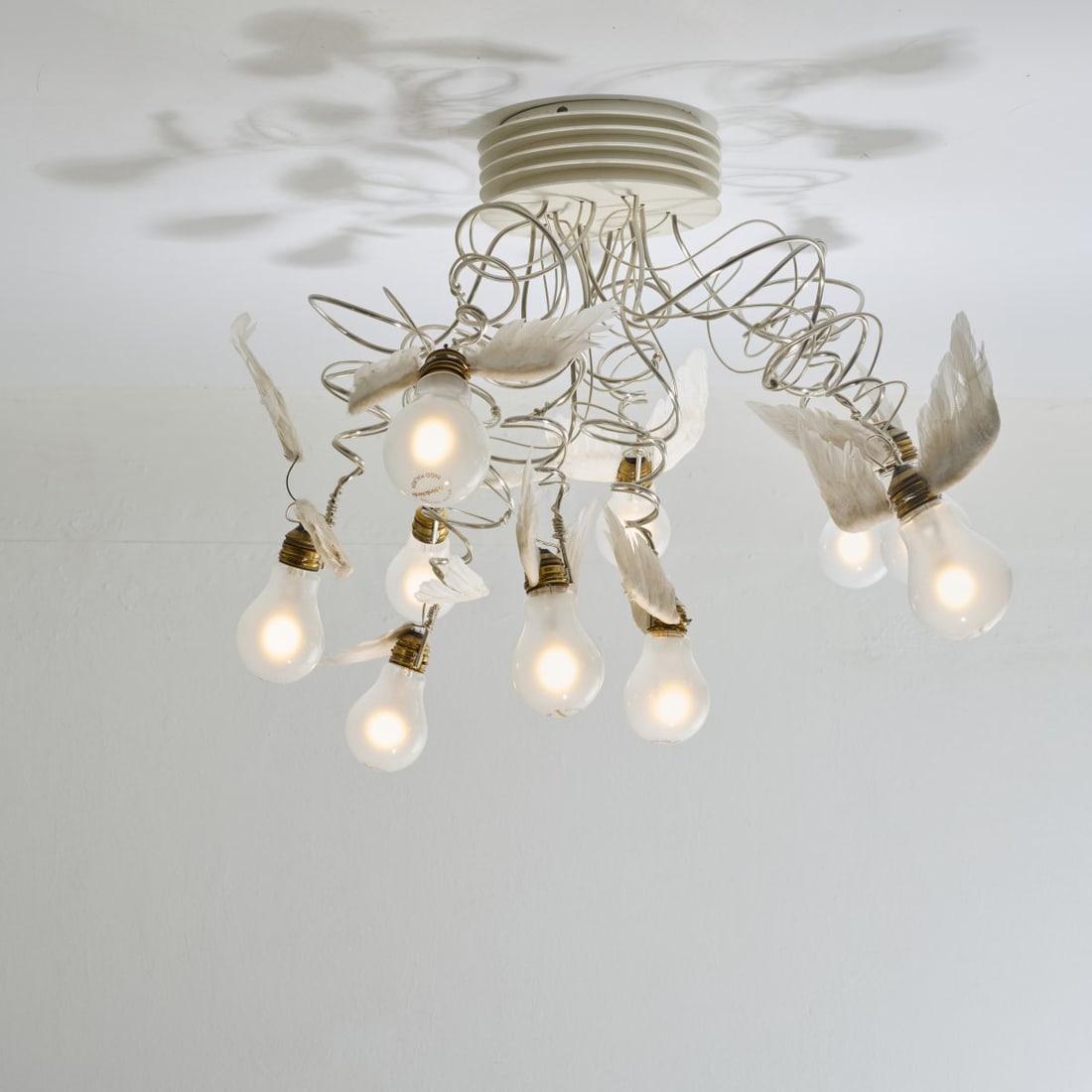 Ingo Maurer, Ceiling light 'Birdie's Nest', 2005 (design): <p>H. 42 cm. <br />Design M, Ingo Maurer, Munich.<br />Sheet metal, varnished white, chrome-plated metal wire, plastic tubing, brass sheet, white plastic, goose feathers. <br />