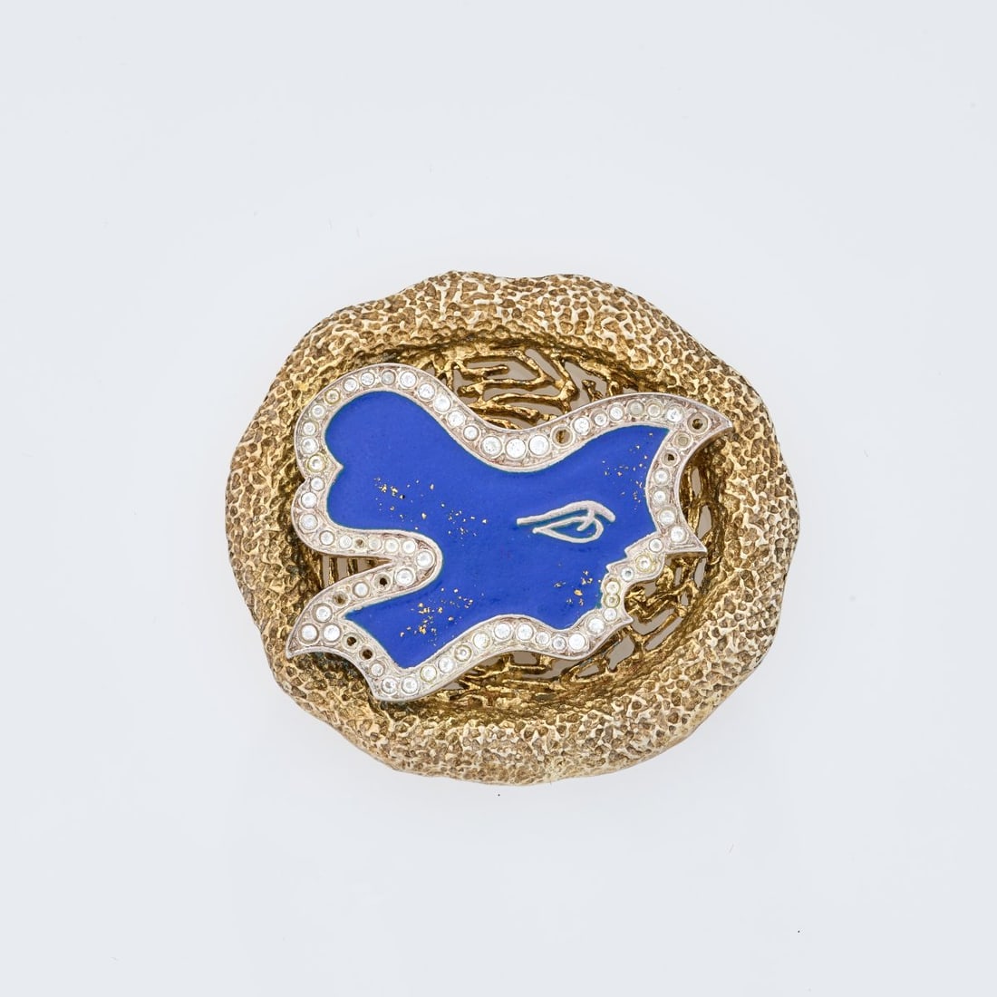 Georges Braque (after), Brooch 'Circe', circa 1963 (design): <p>Sterling silver, gold-plated, blue enamel, rhinestone embellishment. <br />26.30 grams. 42 x 46 mm. <br />Made by Cas Bernard, 1990s. <br />Stamped: BC, 925, Bijoux de G. Br