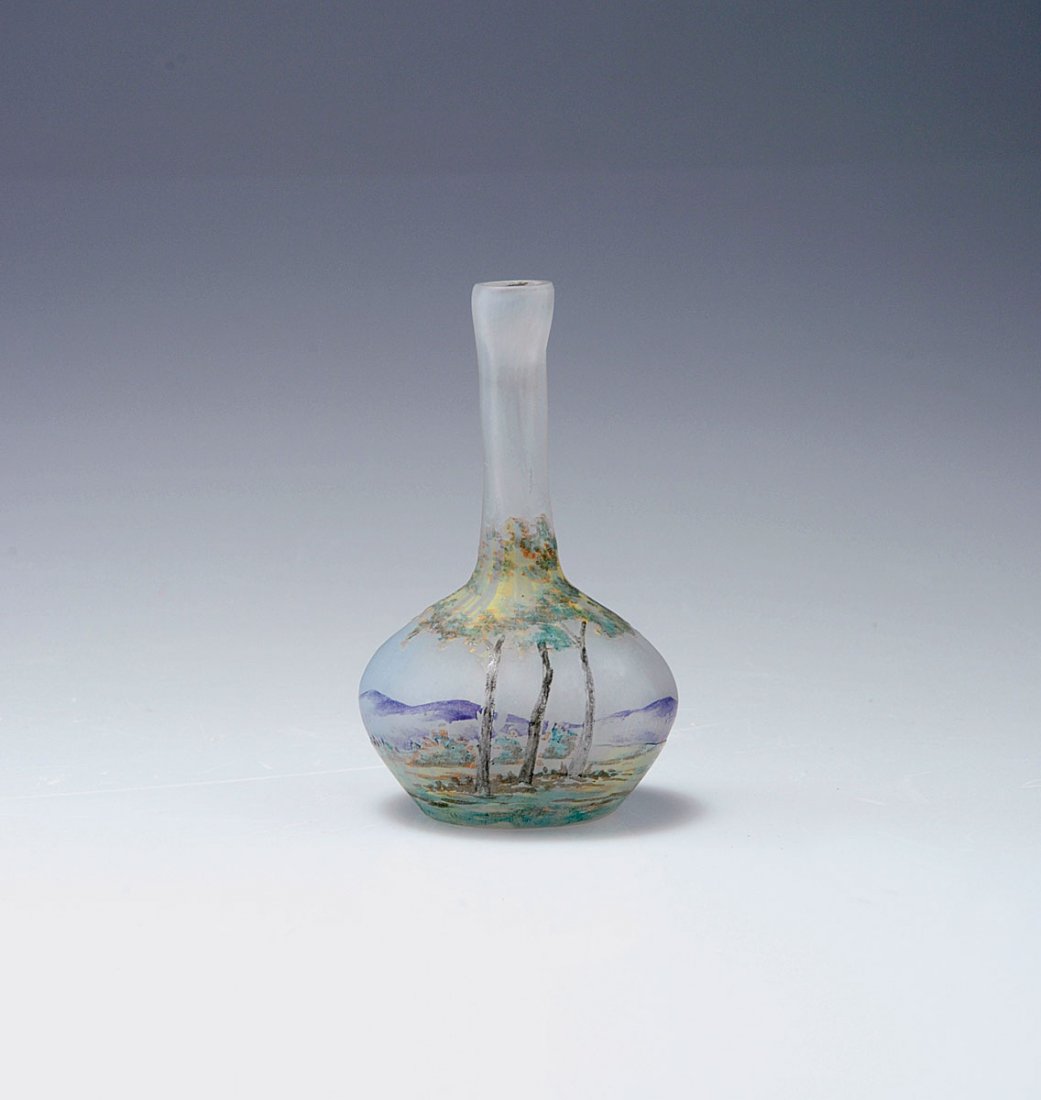 Vase 'Paysage lorrain', 1905-10: Daum Freres, Nancy. 'Paysage lorrain' vase, 1905-10. H. 8 cm. Cased glass, clear, milky light blue powder inclusions, etched and enamelled pattern with Vosges landscape. Signed: DAUM NANCY, cross of L