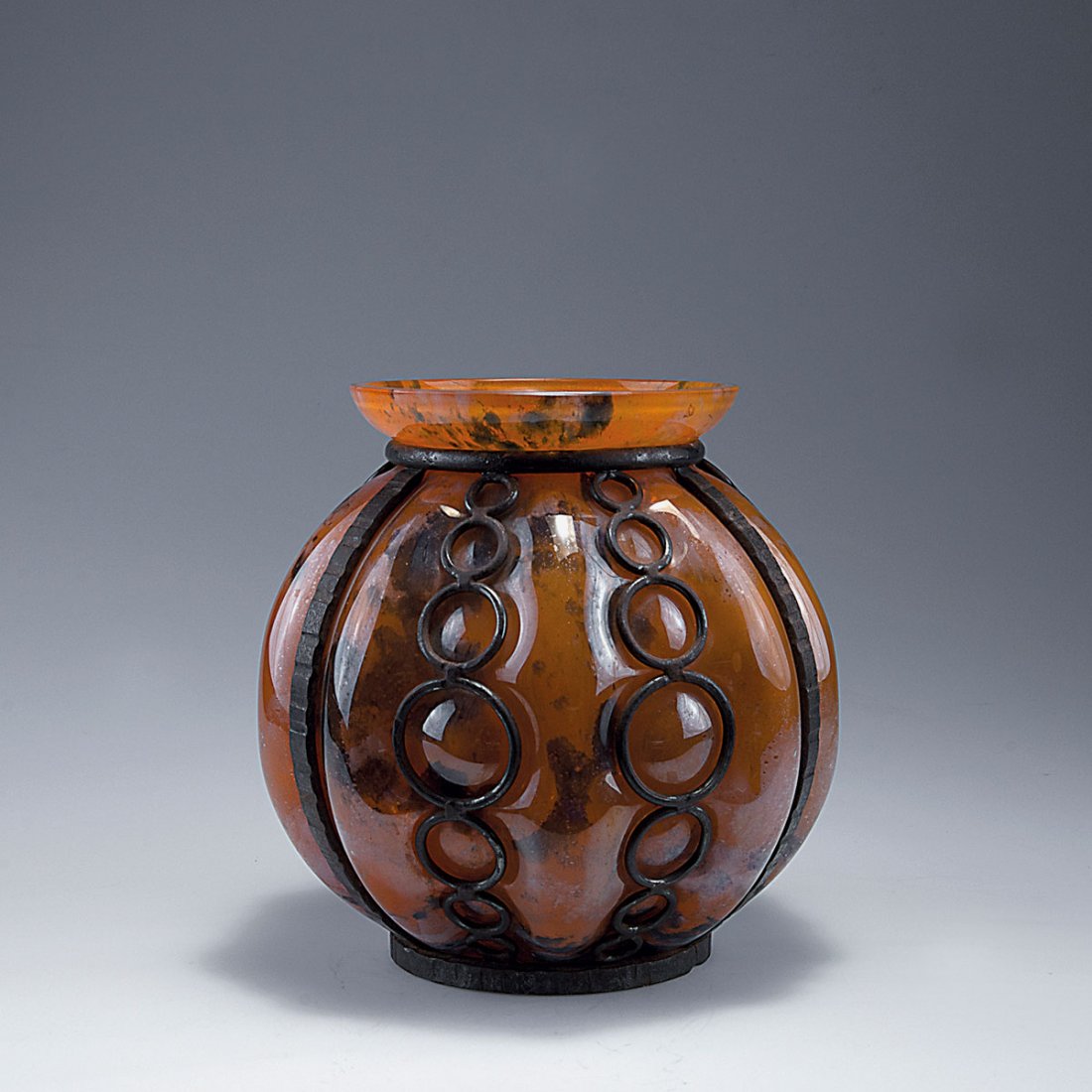 Vase with iron mounting, 1920s: Andre Delatte, Nancy. Vase with iron mounting, 1920s. H. 22.4 cm. Cased glass, clear, orange, white and blue powder inclusions. Black wrought-iron mounting.