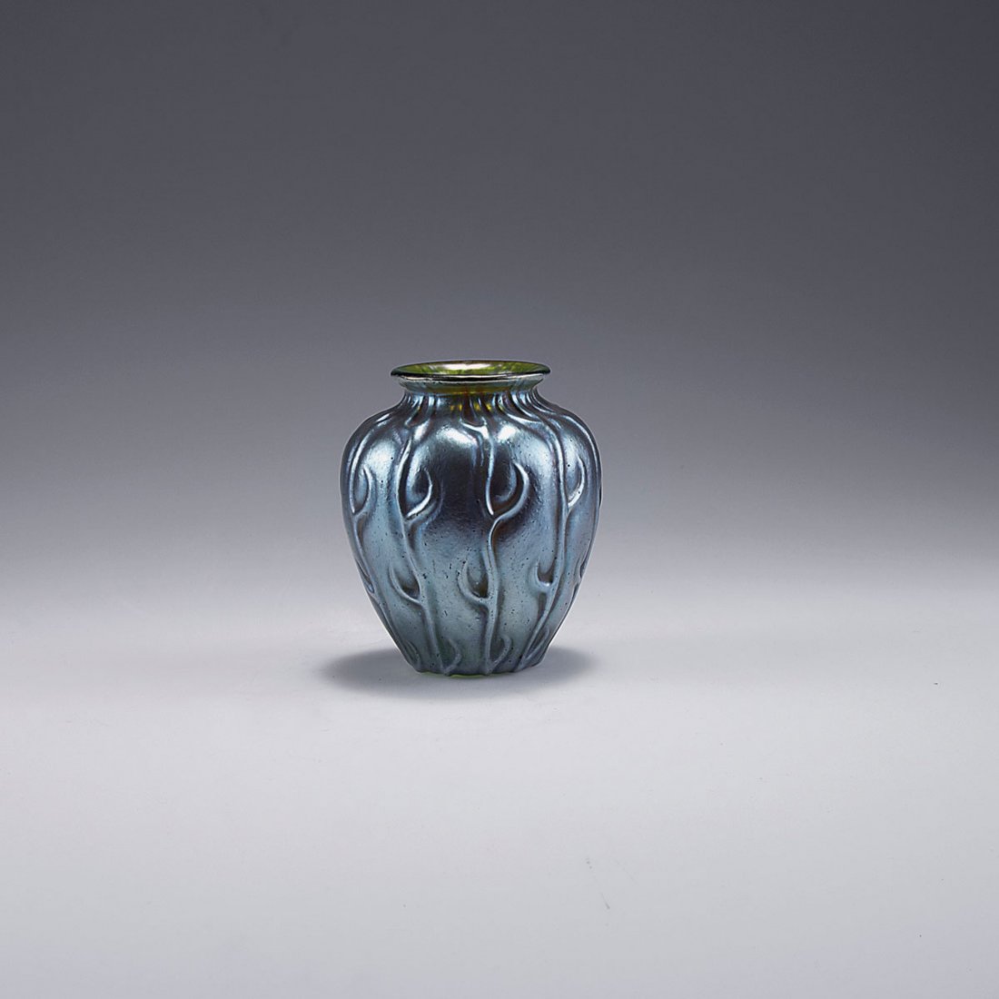 Small 'Neptun' vase, 1902-03: Loetz Wwe., Klostermuehle. Small 'Neptun' vase, 1902-03. H. 9.2 cm. Green glass, reliefed 'Neptun' pattern of thorn-like branches, fused silver yellow crushed glass, matt mother of pearl lustre.