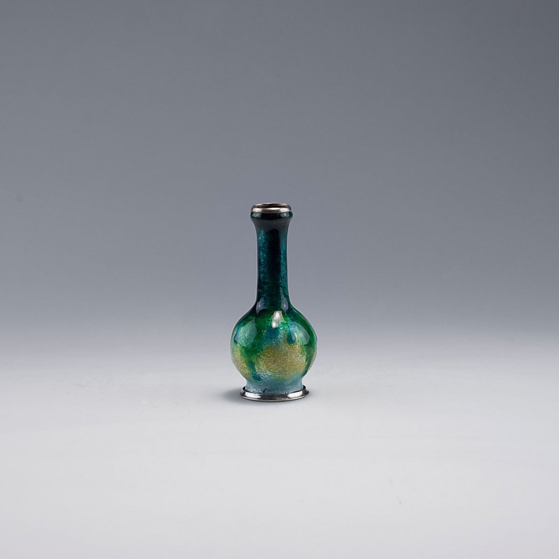 Small vase, c1925: Camille Faure, Limoges. Small vase, c1925. H. 10.2 cm. Copper, applied silver foil, green enamel. Foot and rim silver-plated. Marked: C. FAURE LIMOGES.