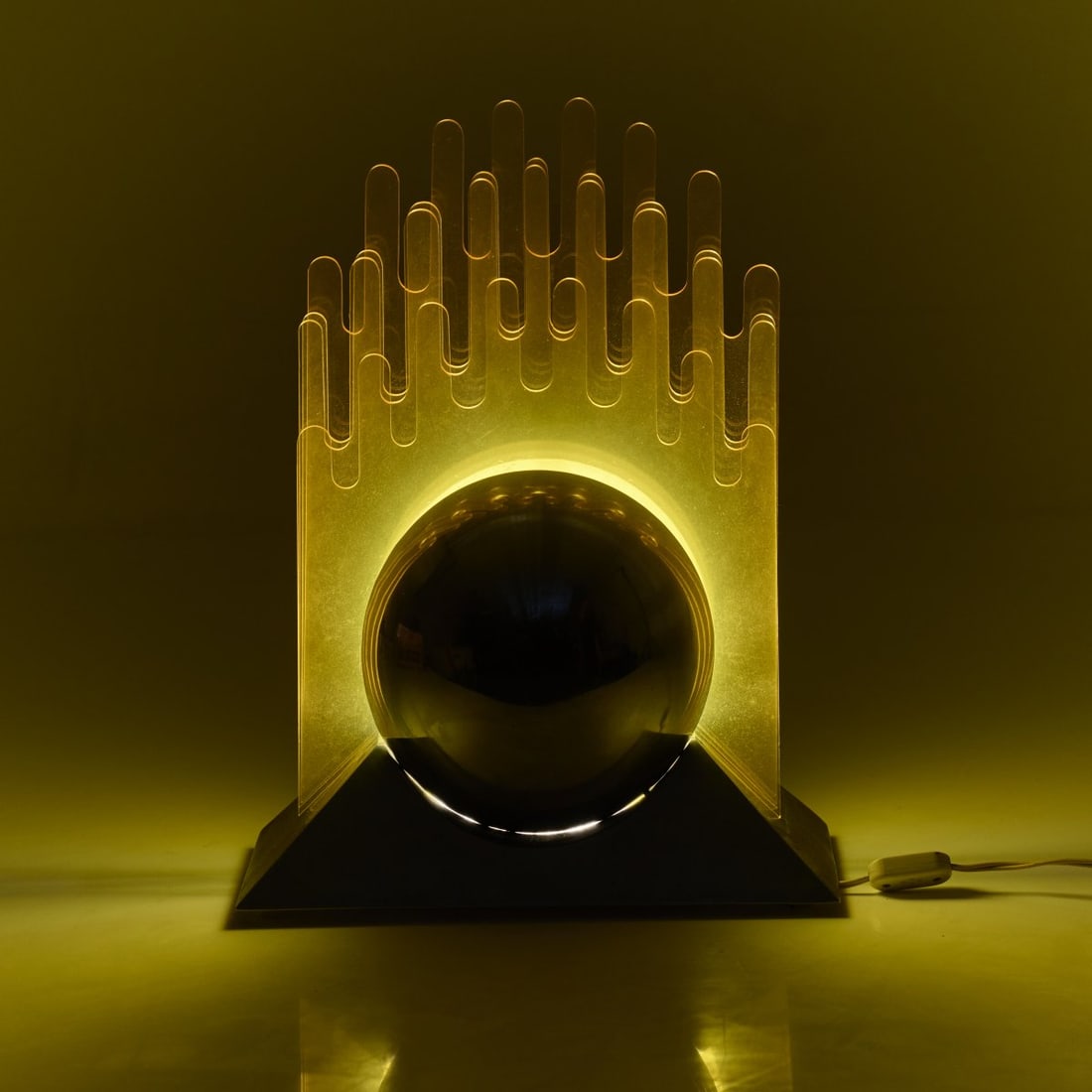 Patrizia Innocenti; Sergio Gobbi, Table light 'Sfera', 1971 (design): <p>H. 53.5 x 39.5 x 21 cm. <br />New Lamp, Milan. <br />Nickel-plated sheet metal, yellow acrylic glass. </p>
