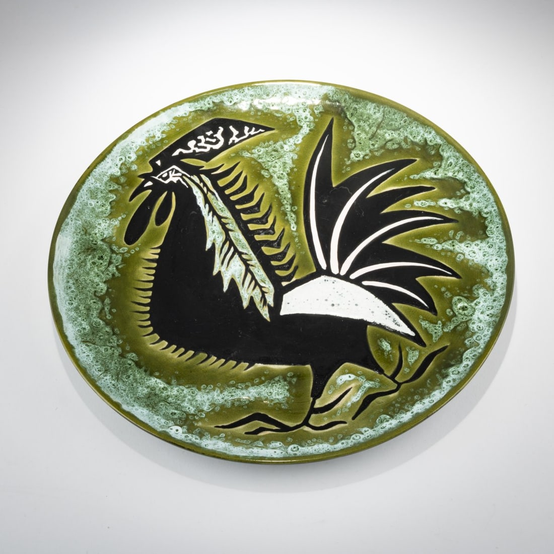 Jean Lurçat , Decorative plate 'Coq', 1950s: <p>H. 3.5 cm, &Oslash; 40.3 cm. <br />Sant-Vicens, Perpignan. <br />Majolica, glazed green and black on white. <br />Marked: Dessin J. Lur&ccedil;at, Sant - Vicens.<