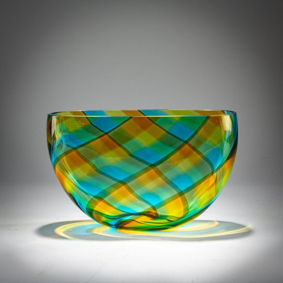 Laura Diaz de Santillana, Bowl 'Magic Colors', 1980: <p>H. 15.4 x 24.8 x 8.7 cm. <br />Rosenthal, Selb. <br />Fused glass ribbons, blue, amber brown and yellow. <br />Marked: Rosenthal studio linie GERMANY, Murano Laura de