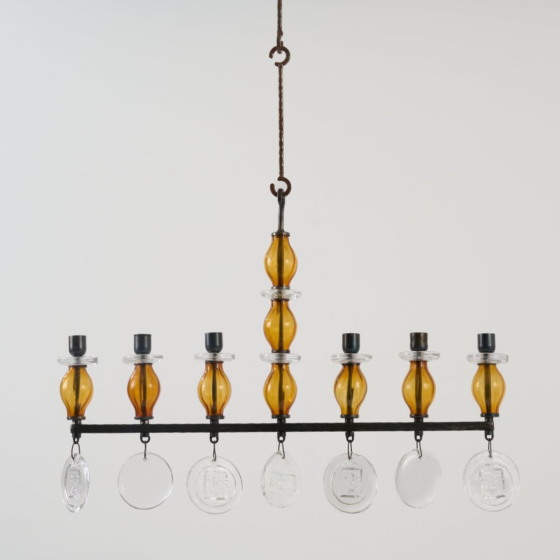 Erik Höglund, Ceiling chandelier, 1960s: <p>H. 46 cm, overall H.: 88 cm; w. 64 cm. <br />Kosta Boda, Boda. <br />Forged metal, blackened, sheet metal, colorless and amber glass. </p>