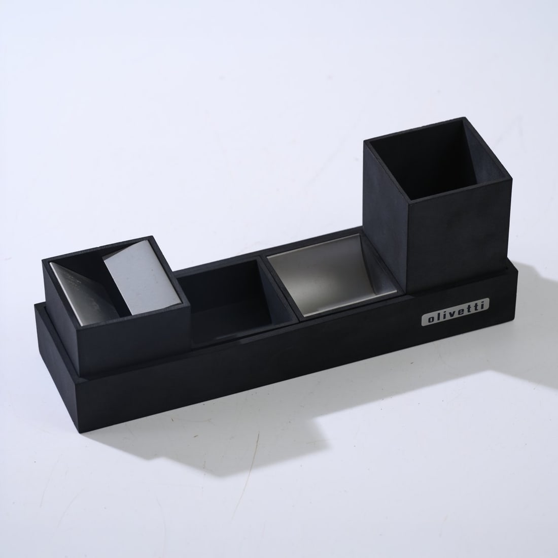 Bruno Munari , Four pieces from the 'Cubo' desk set with ashtray, 1957: <p>H. 3-9 cm, L. 6-25 cm. <br />Danese, Milan. <br />Melamine, black, aluminum sheet. <br />Trays marked: