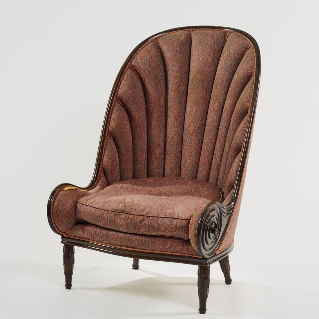 Paul Iribe, Nautilus armchair, 1913 (design): <p>H. 123.5 x 82 x 92.5 cm. <br />Annibale Colombo, Brianza, 1970s/80s. <br />Dark-stained wood, paisley fabric upholstery. </p>
