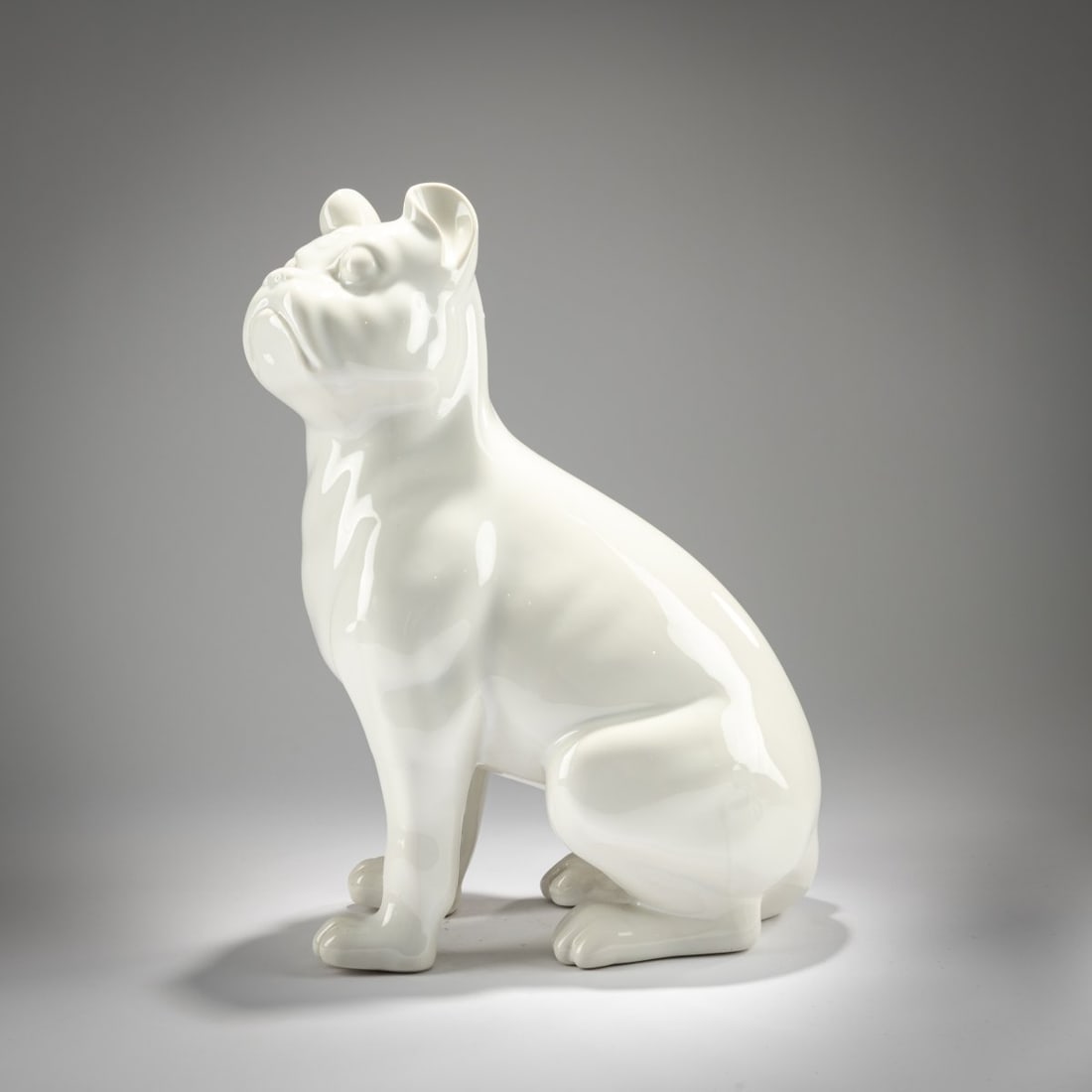 Piero Fornasetti , Dog 'Cani seduti' - 'Bulli', 1950s (design): <p>H. 38.5 cm. <br />Fornasetti, Milan, 1950s-60s. <br />Porcelain, white, glazed. <br />Marked: brush mark, D, S (impressed).</p><hr><p>Literature:</p>