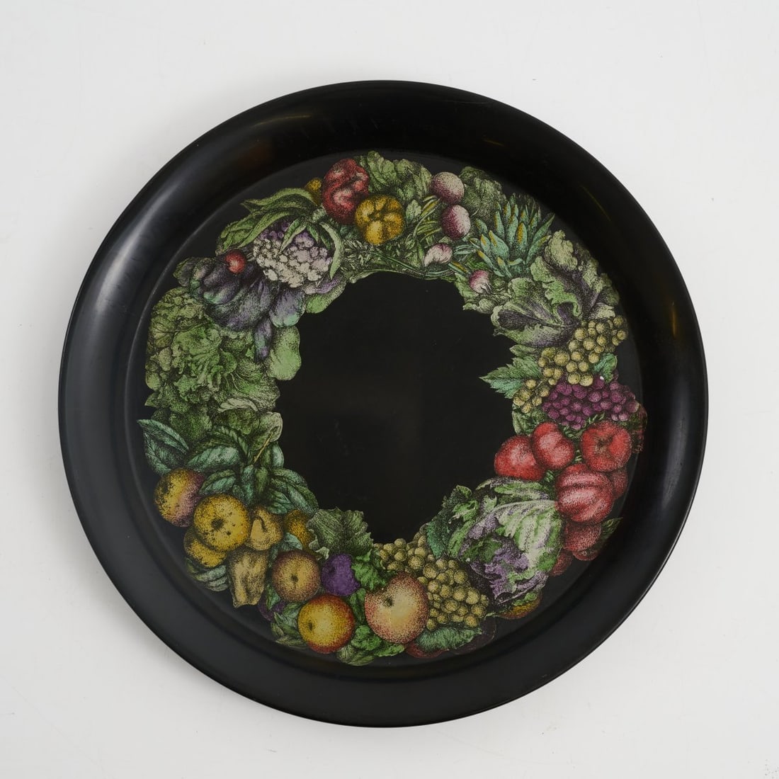 Piero Fornasetti, Tray 'Verdura', 1950s: <p>&Oslash; 40 cm. <br />Fornasetti, Milan. <br />Sheet metal, polychrome print on black. <br />Marked: Manufacturer's label.</p><hr><p>Literature:</p&