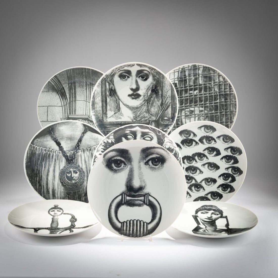 Piero Fornasetti, Nine plates from the 'Tema e Variazioni' series, 1950s - 2000s: <p>&Oslash; 26 cm. <br />Fornasetti, Milan, 1950s to 2000s. <br />Porcelain, white, glazed, black and white lithograph print. <br />Marked: series designation and number, b