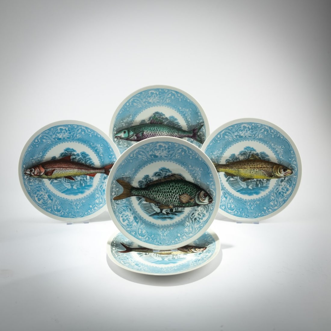 Piero Fornasetti, Eleven plates from the 'Marinara, Piscibus' series, 1950s (design): <p>&Oslash; 26 cm. <br />Fornasetti, Milan; Sch&ouml;nwald, porcelain factory, 1955. <br />Porcelain, white, glazed, polychrome lithographic decoration. <br />Marked: b