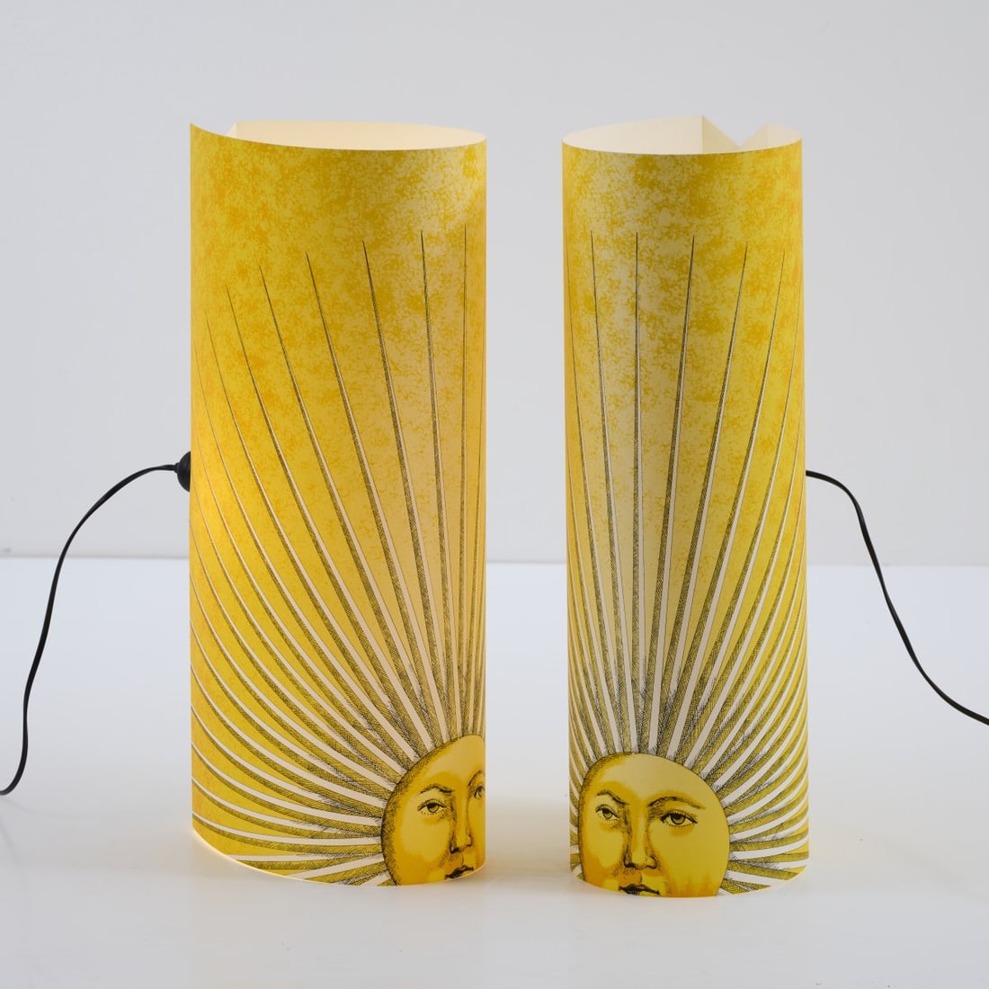 Barnaba Fornasetti, Two floor lamps 'Sole', 1995 (design): <p>H. 60.3 x 18.5 x 25.5 cm. <br />Antonangeli Illuminazione, Paderno Dugnano/Milan. <br />White plastic, polychrome lithograph. <br />Marked: brush mark, manufacturer's inform